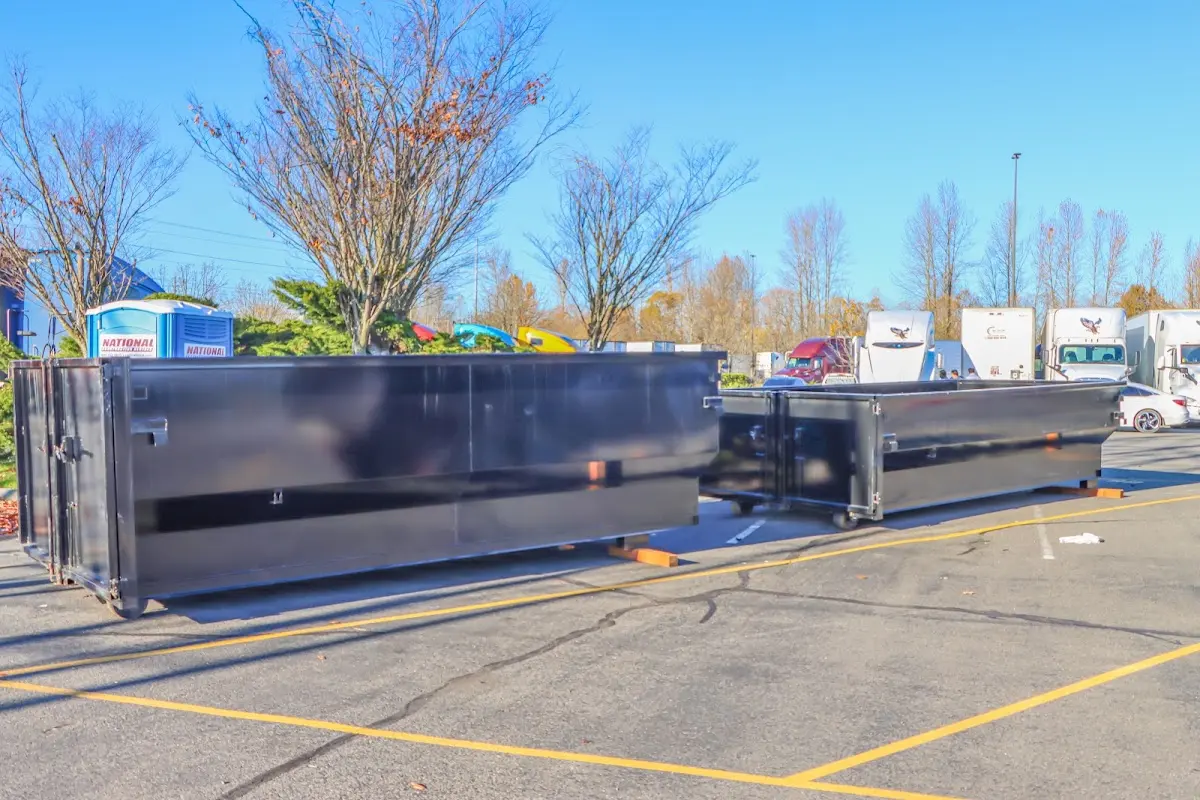 Professional dumpster rental service with roll-off container on residential driveway in Annandale